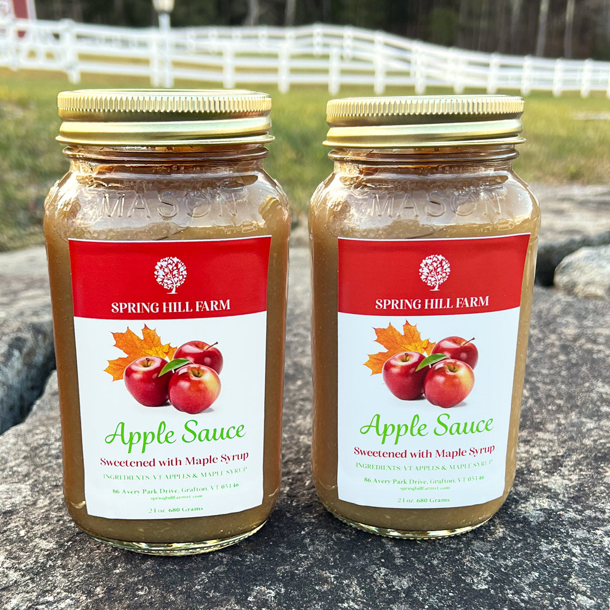 two glass jars of farm fresh apple sauce sweetened with Vermont maple syrup.