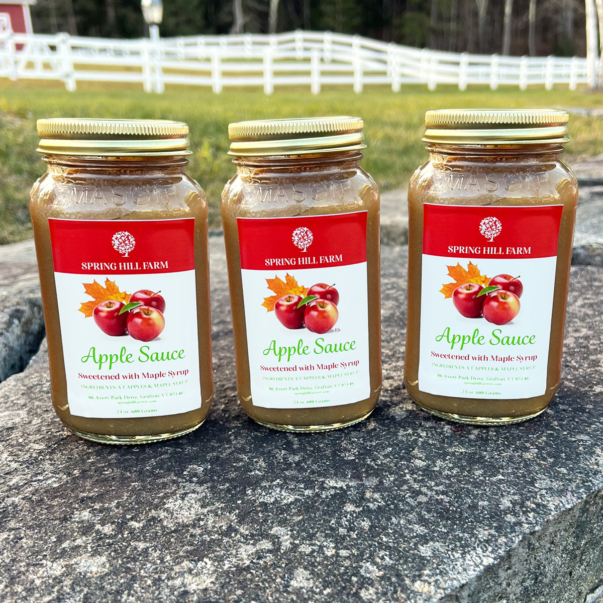 three glass jars of farm fresh apple sauce sweetened with Vermont maple syrup.